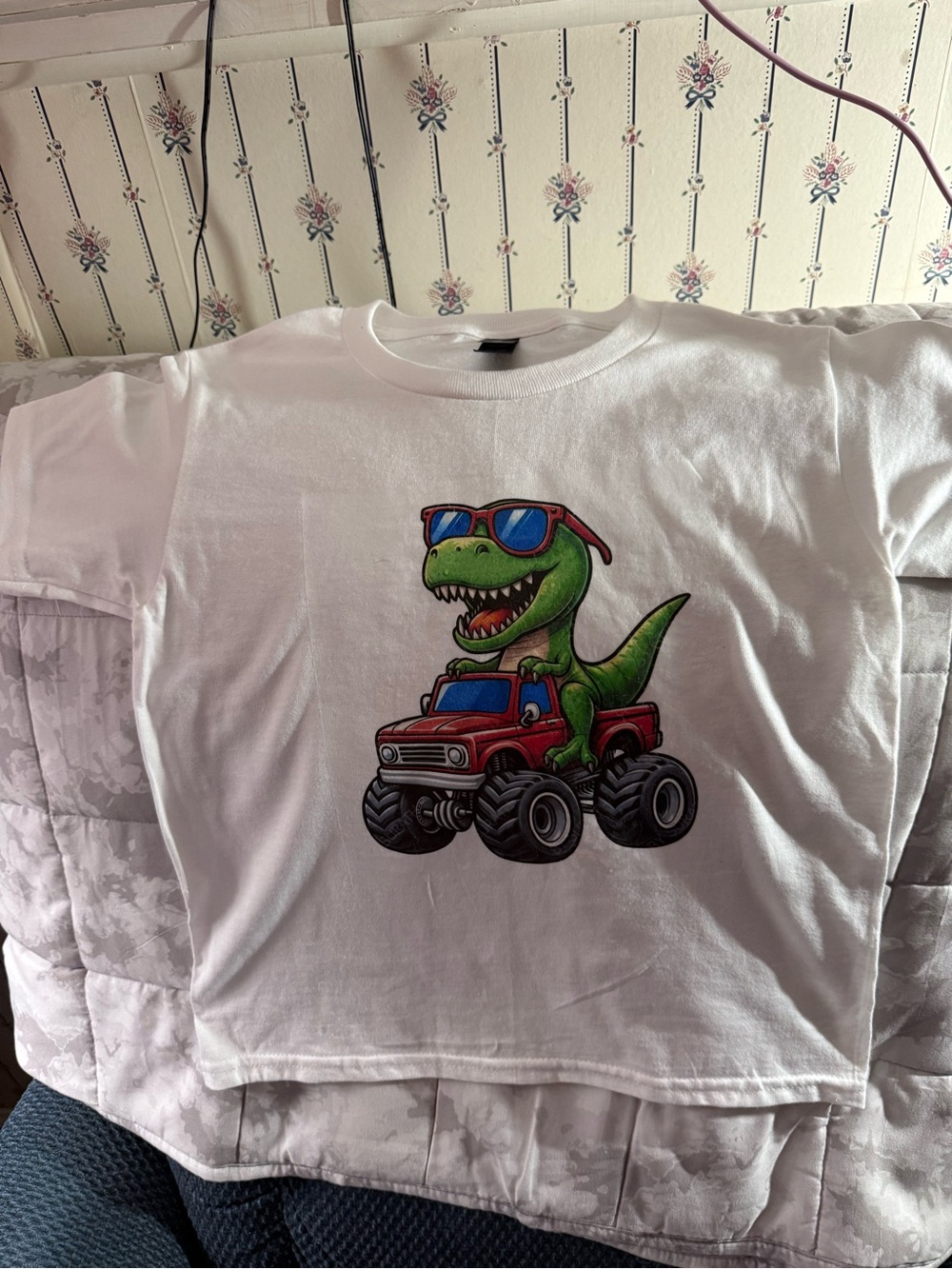 White Kids T‑Shirt with Green Dinosaur Driving Red Monster Truck